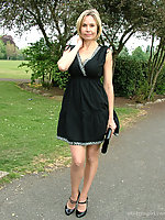 Hot Milf Monica posing in a gorgeous short black dress with matching shiny high heels